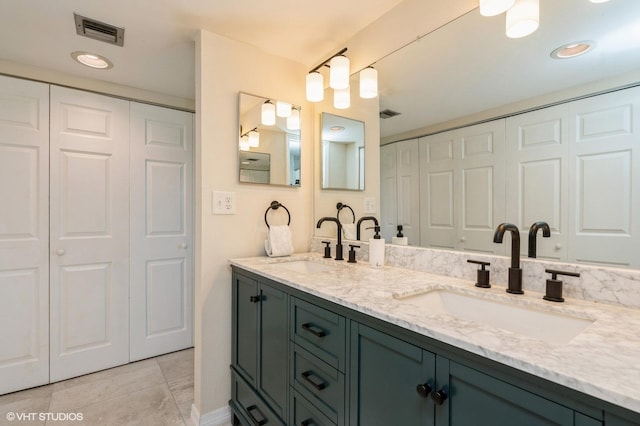 bathroom with tile patterned flooring and vanity