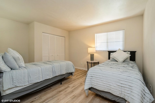 bedroom featuring light wood-type flooring and a closet