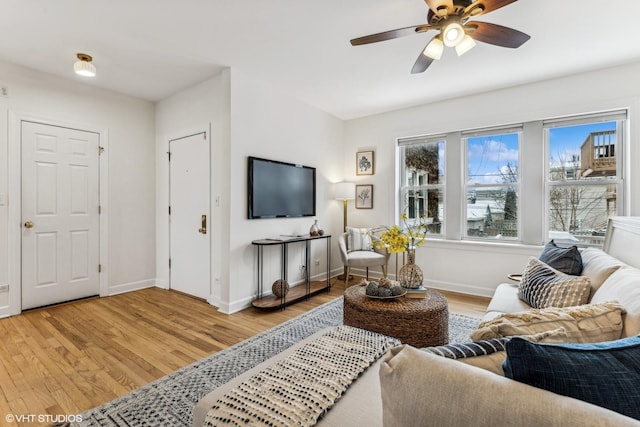 living room featuring ceiling fan and light hardwood / wood-style floors