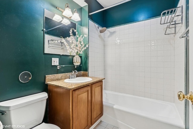 full bathroom with tile patterned floors, vanity, tiled shower / bath combo, and toilet