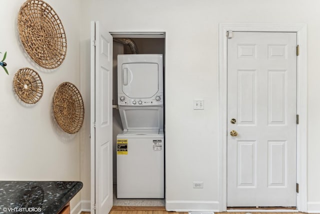 laundry area featuring stacked washing maching and dryer