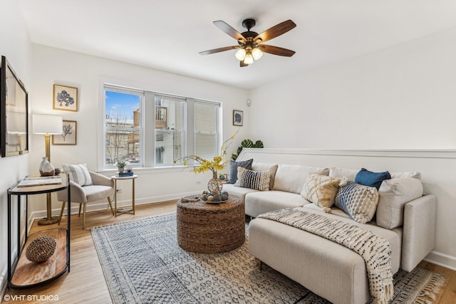 living area featuring ceiling fan and light hardwood / wood-style floors