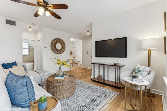 living room with ceiling fan and hardwood / wood-style flooring