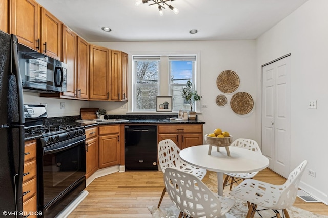 kitchen featuring light hardwood / wood-style flooring and black appliances