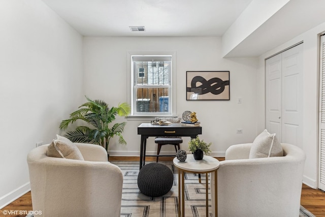 sitting room featuring dark hardwood / wood-style flooring