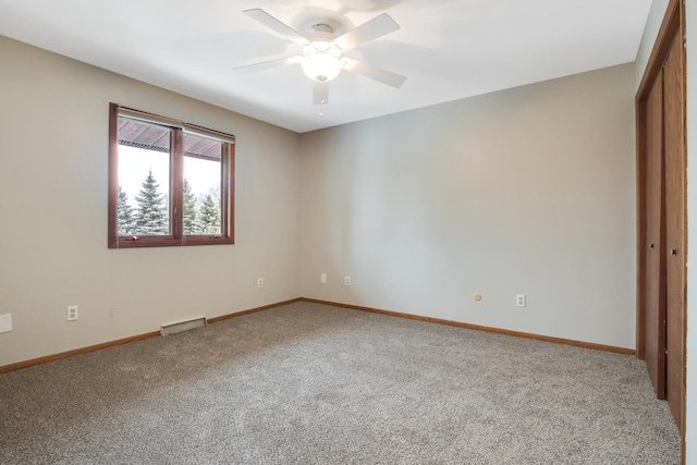 unfurnished bedroom with ceiling fan, a closet, and carpet