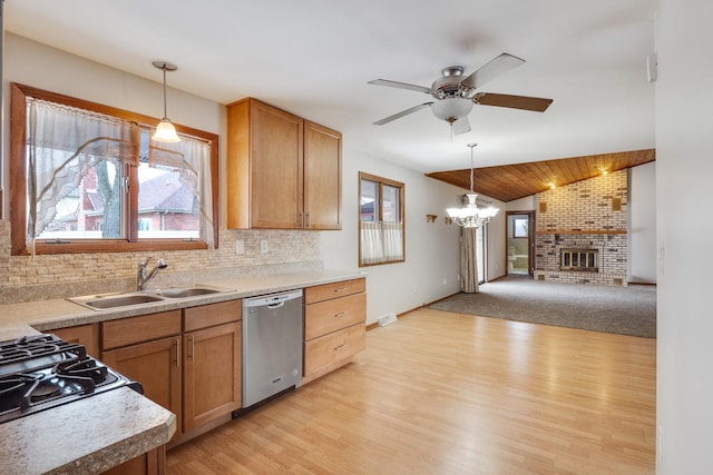 kitchen featuring hanging light fixtures, dishwasher, sink, and plenty of natural light