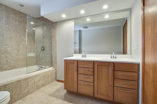 full bathroom featuring toilet, tiled shower / bath combo, tile patterned floors, and vanity