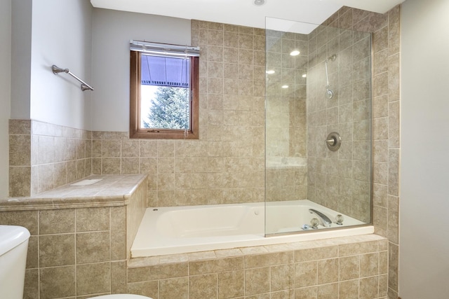 bathroom featuring toilet and tiled shower / bath