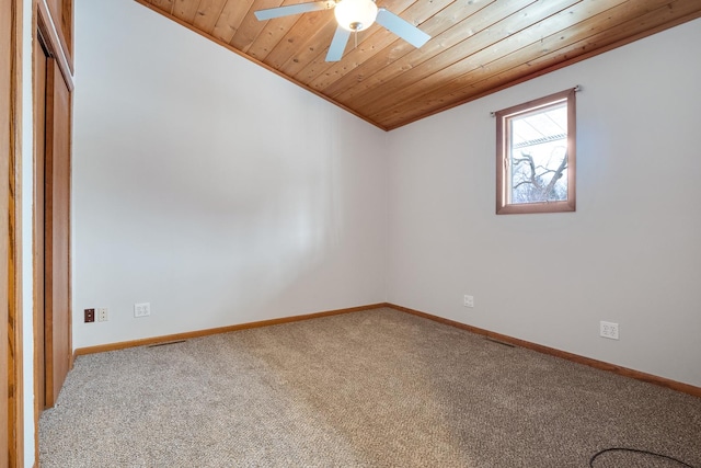 carpeted empty room with ceiling fan, wood ceiling, and vaulted ceiling