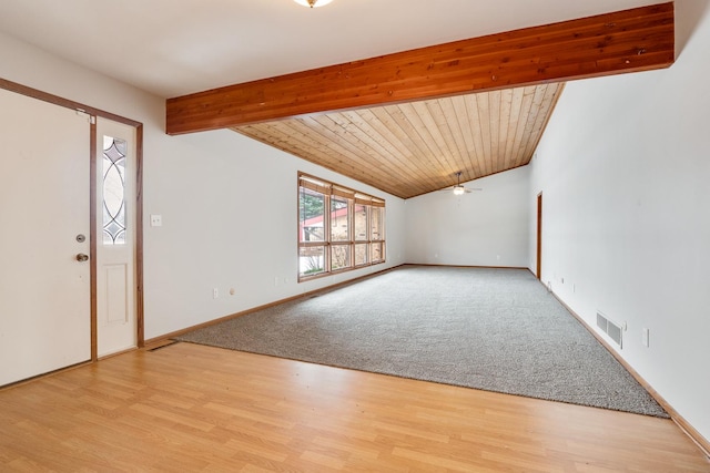 foyer entrance with ceiling fan, wooden ceiling, light carpet, and beam ceiling