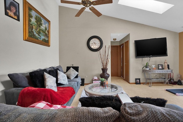 carpeted living room featuring ceiling fan and lofted ceiling with skylight