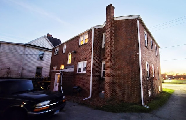 view of back house at dusk