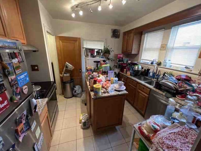 kitchen with a center island, light tile patterned flooring, and appliances with stainless steel finishes