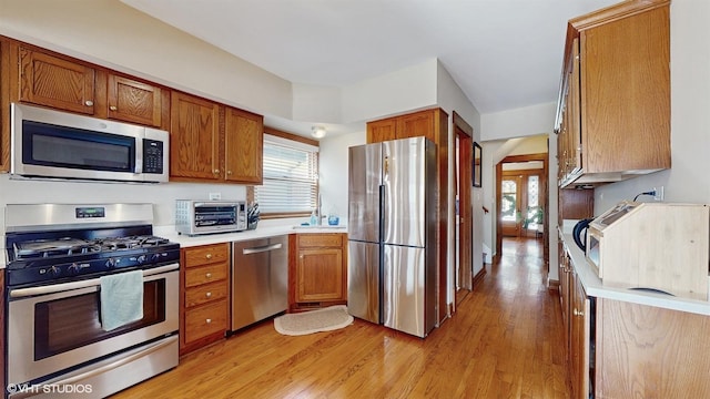 kitchen featuring appliances with stainless steel finishes and light hardwood / wood-style floors