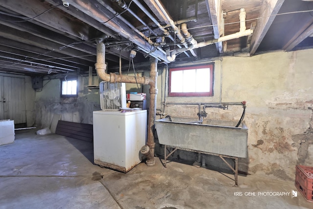 basement featuring washer / dryer and sink