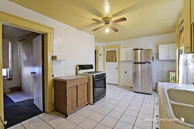 kitchen with white appliances, ceiling fan, sink, white cabinets, and light tile patterned flooring