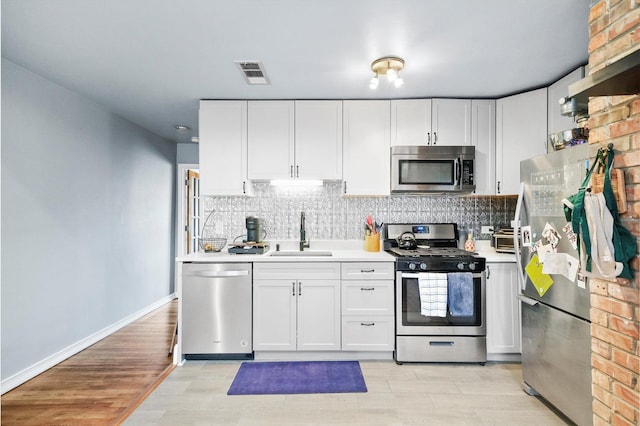 kitchen featuring white cabinetry and stainless steel appliances