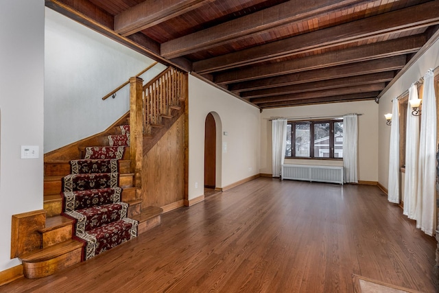 unfurnished living room with wooden ceiling, radiator heating unit, dark hardwood / wood-style floors, and beam ceiling