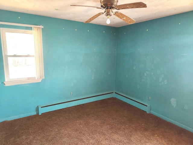 carpeted spare room featuring baseboards, ceiling fan, and a baseboard heating unit