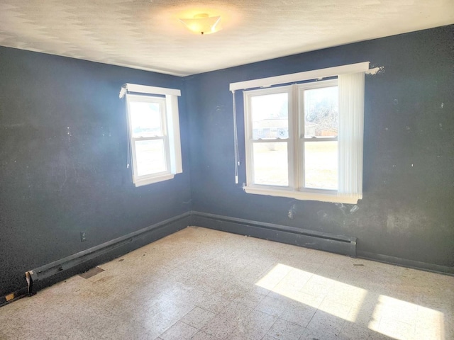 unfurnished room with tile patterned floors and baseboards
