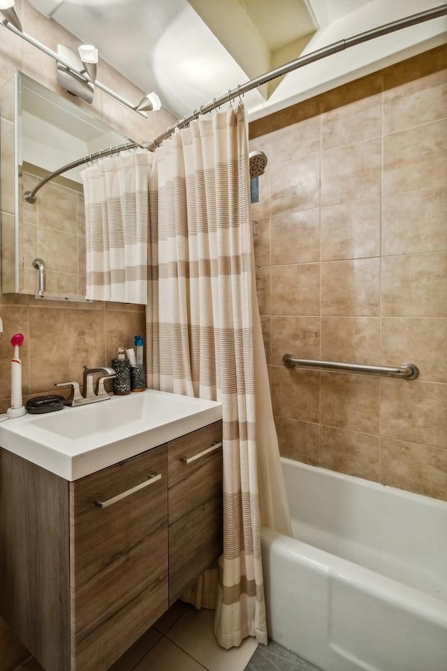 bathroom featuring backsplash, tile patterned floors, vanity, shower / bathtub combination with curtain, and tile walls