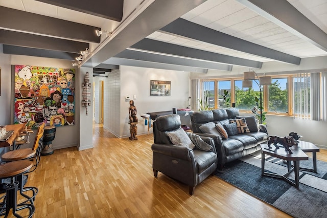 living room with beam ceiling and light hardwood / wood-style floors