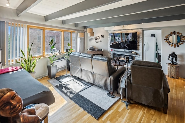 living room with beamed ceiling and light hardwood / wood-style flooring