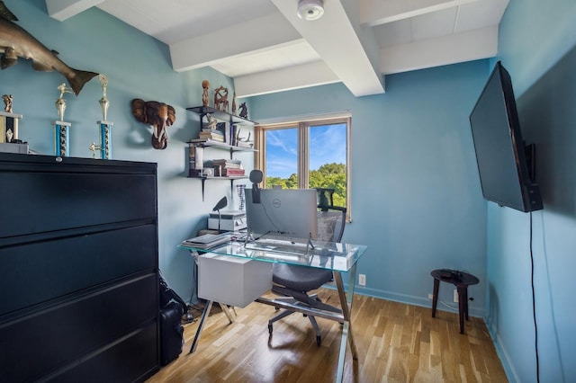 office space with beam ceiling and light wood-type flooring