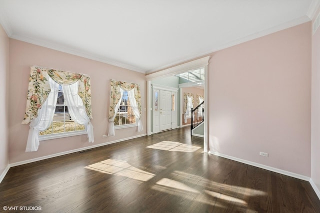 spare room with dark hardwood / wood-style flooring and ornamental molding