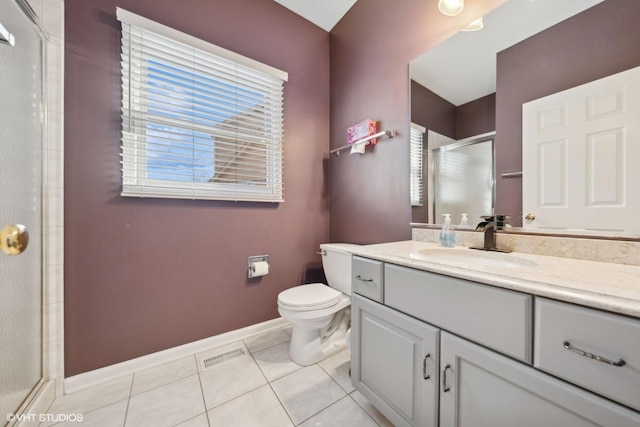 bathroom featuring toilet, vanity, tile patterned floors, and an enclosed shower