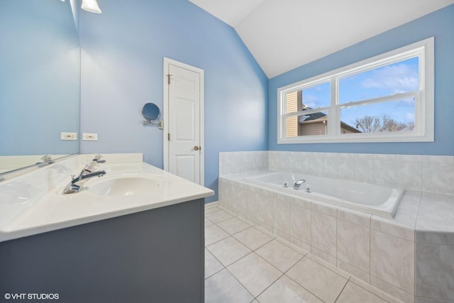 bathroom with tile patterned floors, tiled bath, vanity, and vaulted ceiling