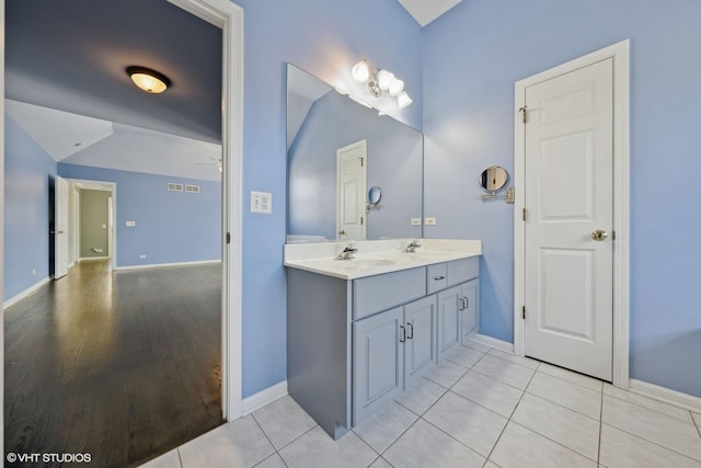 bathroom featuring tile patterned floors, vanity, and ceiling fan