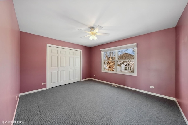 unfurnished bedroom featuring ceiling fan, a closet, and carpet floors