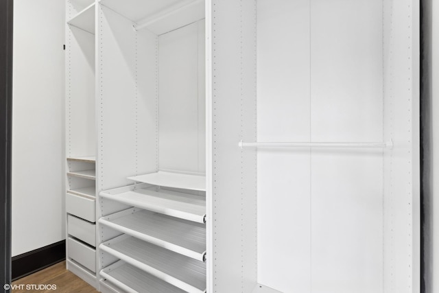 walk in closet featuring hardwood / wood-style flooring