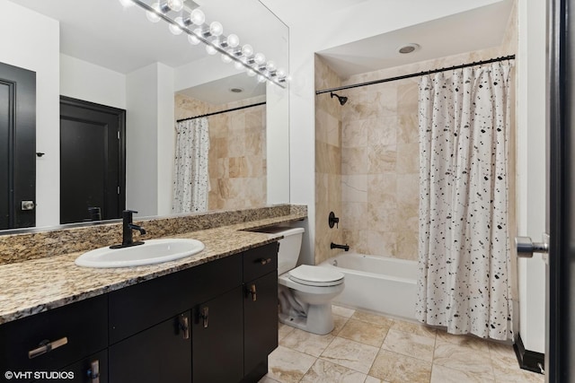 full bathroom featuring vanity, shower / tub combo, and toilet