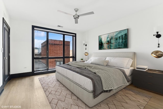 bedroom with light hardwood / wood-style floors and ceiling fan