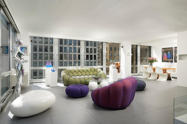 living room featuring a baseboard radiator and floor to ceiling windows