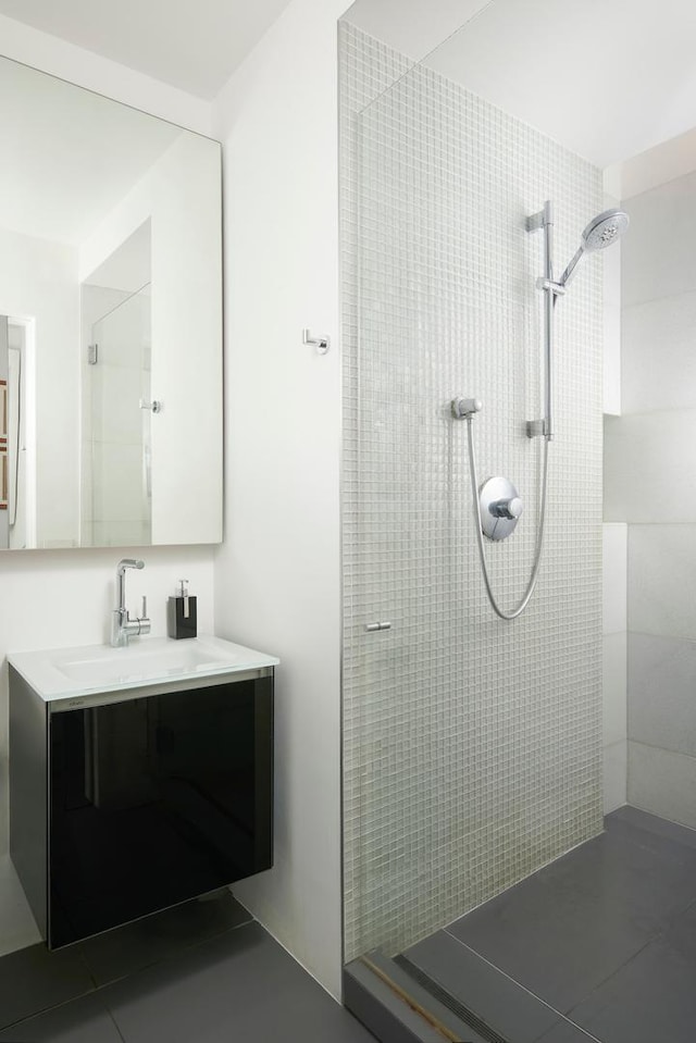 bathroom with vanity, tile patterned floors, and tiled shower