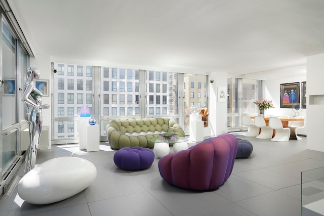 living room with floor to ceiling windows and a baseboard heating unit