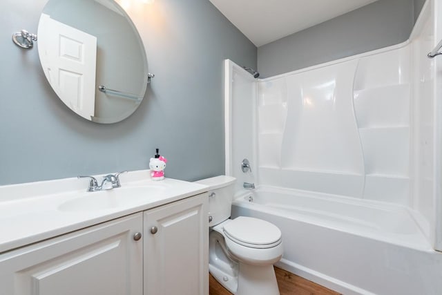 full bathroom with vanity, hardwood / wood-style floors, shower / bathtub combination, and toilet