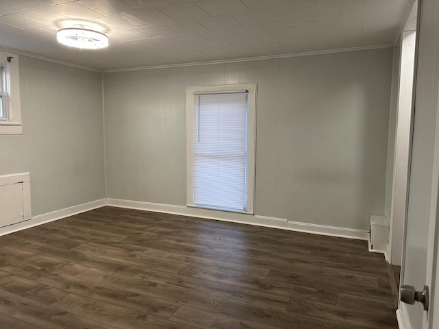 unfurnished room with dark hardwood / wood-style flooring and crown molding