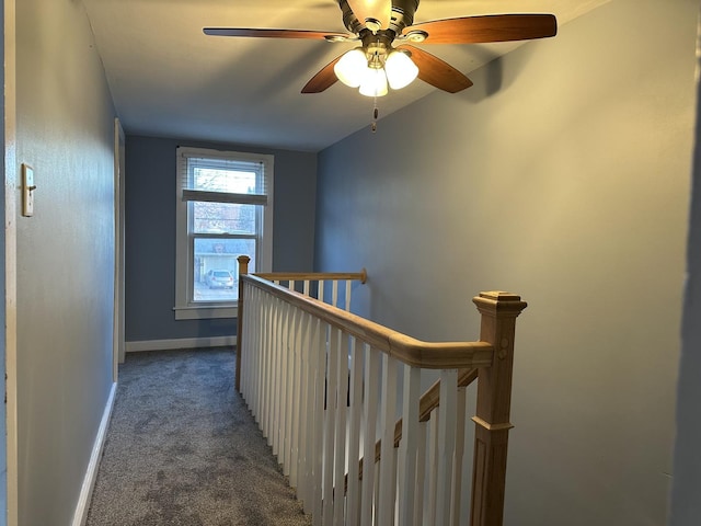 hallway with lofted ceiling and dark carpet