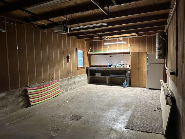 basement with fridge and a workshop area