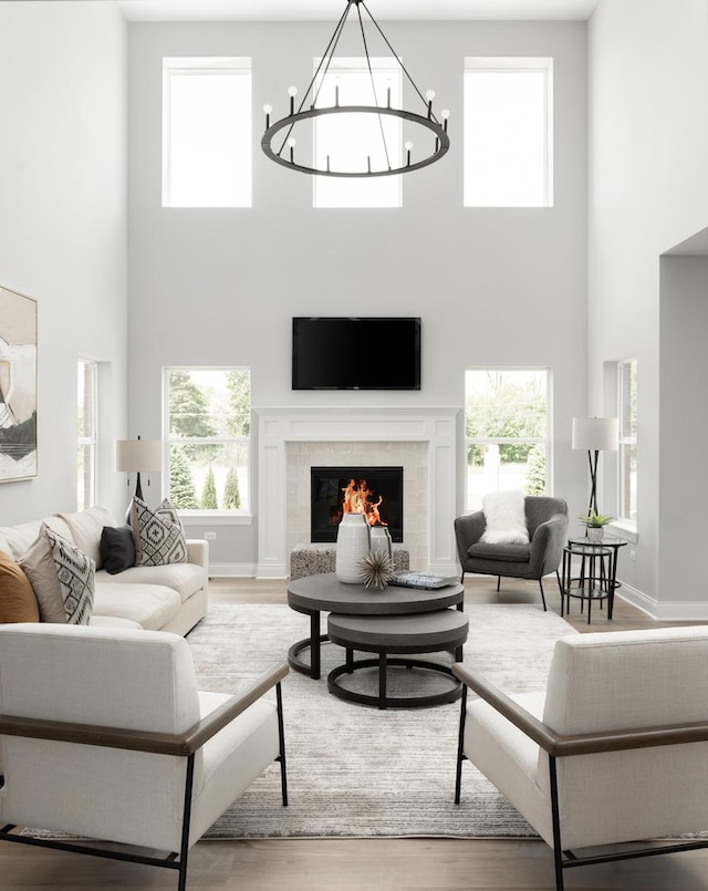 living room with a fireplace, hardwood / wood-style floors, and a high ceiling