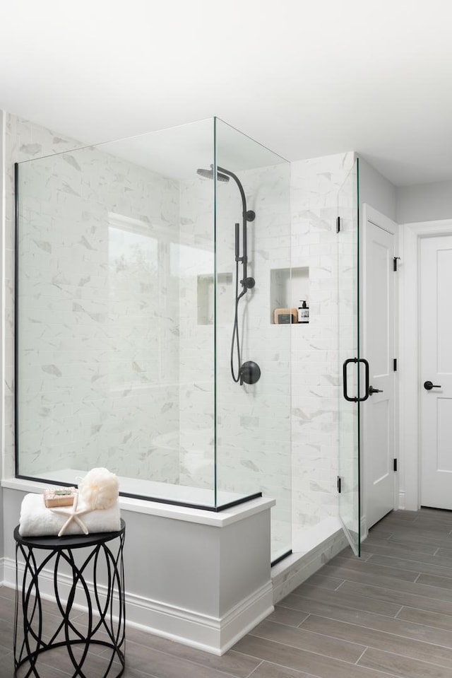 bathroom featuring a shower with shower door