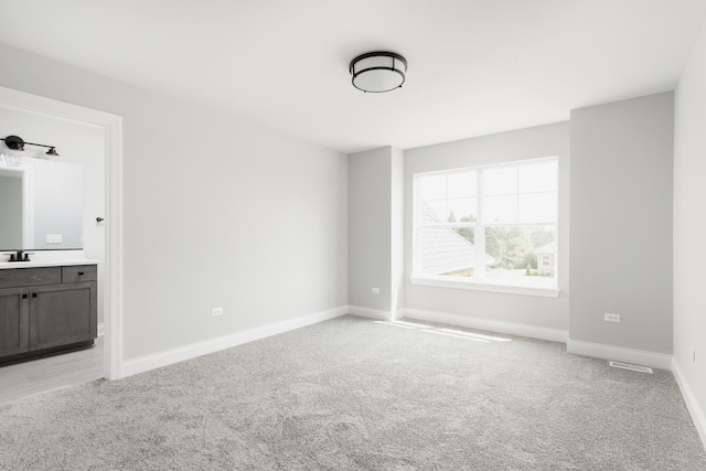 interior space with sink and light carpet