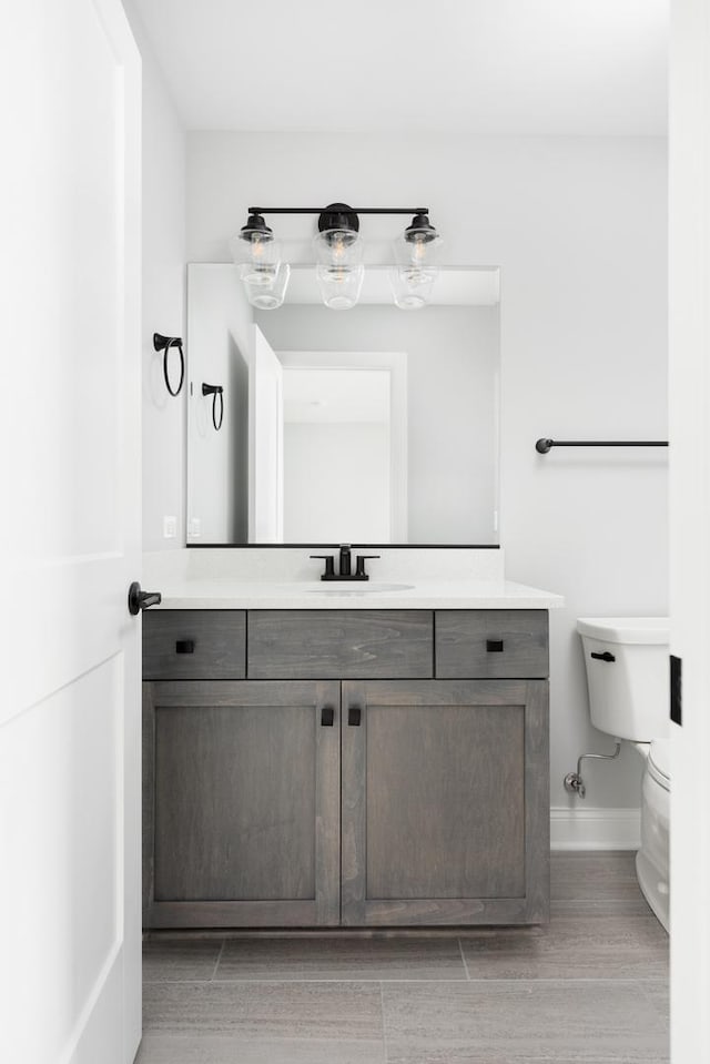 bathroom with toilet and vanity