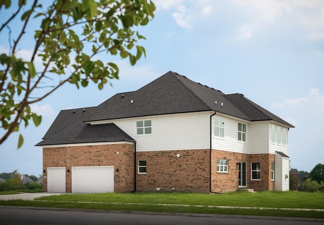 view of side of home with a yard and a garage