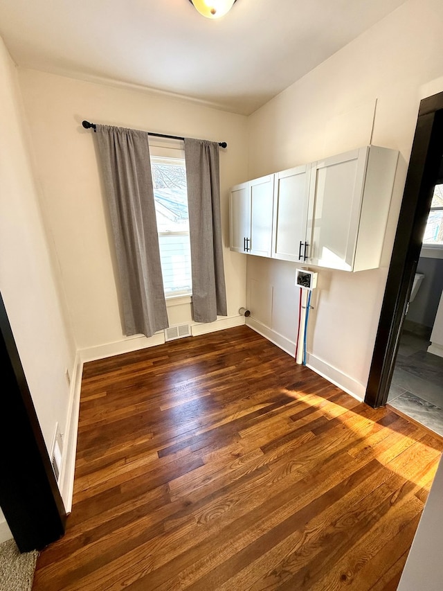 empty room with dark wood-type flooring